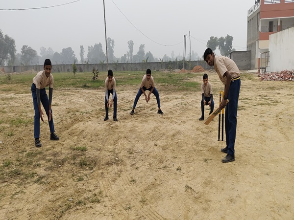 Students playing cricket